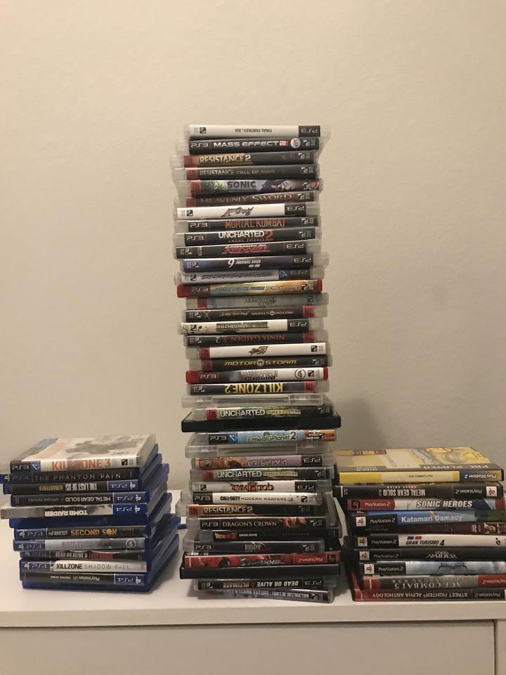 Some of my PS2 and PS3 games not in storage along with some of my PS4 games