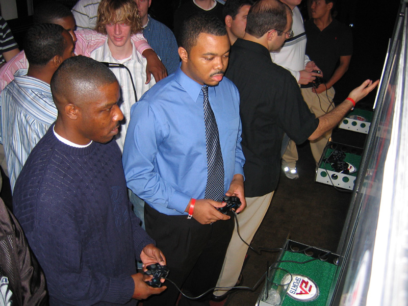 Jets corner Ray Mickens, left, goes up against Madden finalist Booker T in the Pro-Am Challenge.