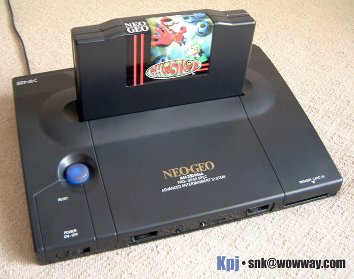 The NeoGeo home console with a cartridge inserted.