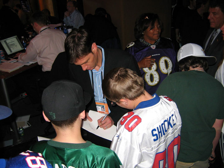 ESPN's Mike Greenberg signs some autographs on the floor of Radio City Music Hall.