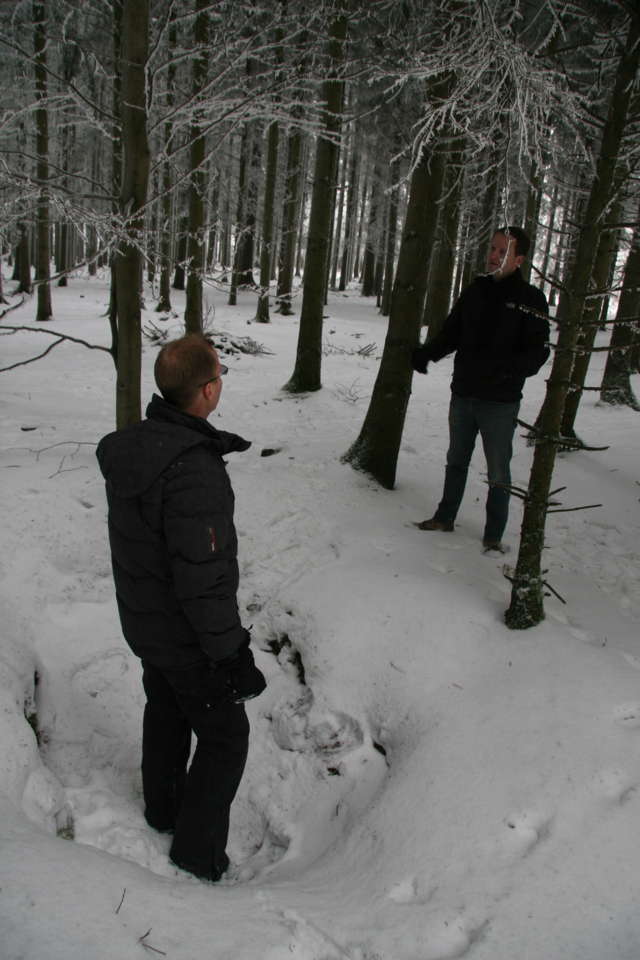 Michael Condrey (left) and Martin Morgan surveying foxholes occupied by 101st Airborne during Battle of the Bulge, in Bois Jacques, part of the Ardennes Forest just outside Foy, Belgium. 