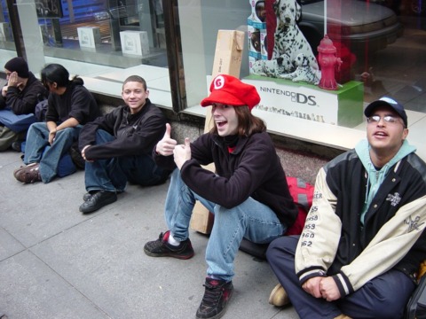 Reggie's army gets ready for the launch, at rest in front of the Nintendo World Store in Manhattan.
