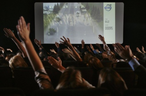 The audience test-drives the new Volvo from their cinema seats at a press event last night.