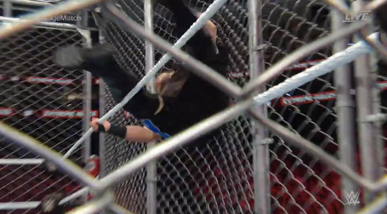 Kevin Owens Gets Sent Into The Cage Wall