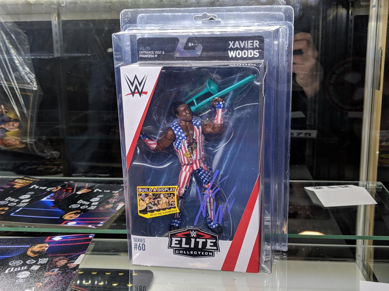 18. Signed items, including this Xavier Woods action figure