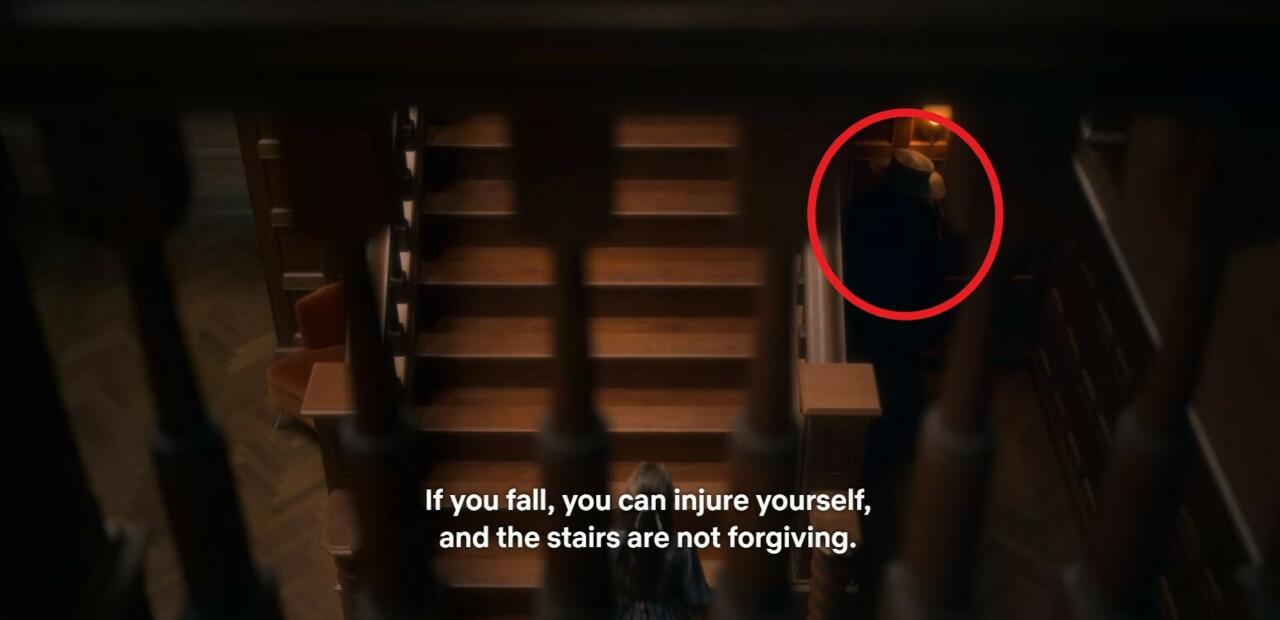 3.) Episode 1, 21:01, standing on the right side of the stairs as Flora says "if you fall you can injure yourself."